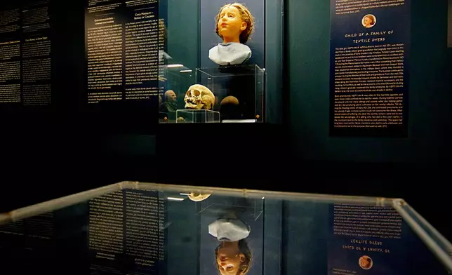 A Roman-era skulls and its facial reconstructions is on display at the Aquincum Museum's exhibition titled "Once we were like you" which showcases characters and the fictional life stories of those who once lived in the bustling Roman settlement of Aquincum, in Budapest, Hungary, Tuesday, July 7, 2026. (AP Photo/Bela Szandelszky)