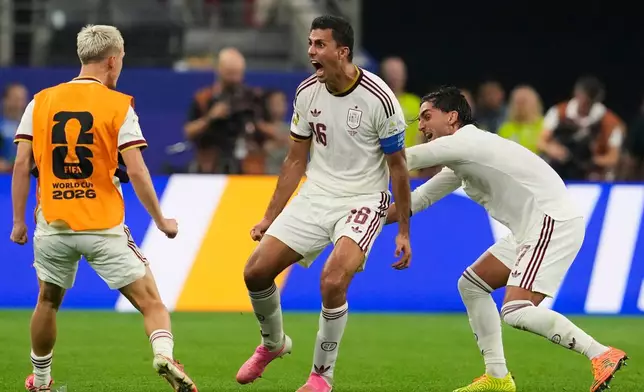 Spain's Ferran Torres (7) and Spain's Rodri (16) celebrate after Spain's Mikel Merino (6) scored their first goal during the World Cup round of 16 soccer match between Portugal and Spain in Arlington, Texas, near Dallas, Monday, July 6, 2026. (AP Photo/Tony Gutierrez)