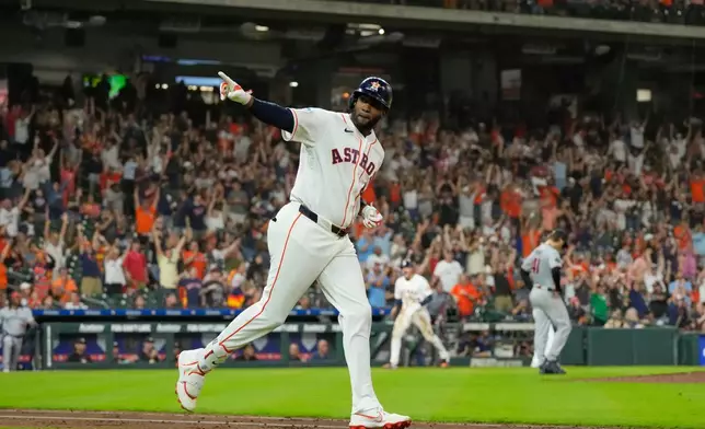 Houston Astros' Yordan Alvarez celebrates after hitting a grand slam against the Minnesota Twins during the fourth inning of a baseball game Tuesday, June 30, 2026, in Houston. (AP Photo/David J. Phillip)