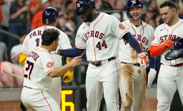 Houston Astros' Yordan Alvarez (44) celebrates with Jose Altuve (27) after hitting a grand slam against the Minnesota Twins during the fourth inning of a baseball game Tuesday, June 30, 2026, in Houston. (AP Photo/David J. Phillip)