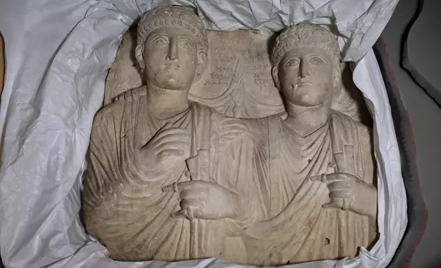 Palmyrene funerary reliefs that once adorned the walls of tombs and date to the second and third centuries A.D. are displayed after Syrian authorities unveiled antiquities returned from France at the National Museum in Damascus, Syria, Wednesday, July 8, 2026. (AP Photo/Ghaith Alsayed)