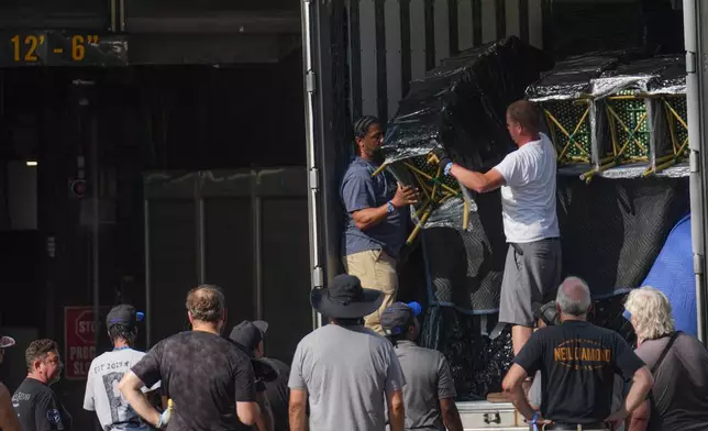 A work crew unloads chairs from a truck outside of Madison Square Garden ahead of a reported wedding between singer Taylor Swift and National Football League player Travis Kelce on Thursday, July 2, 2026, in New York. (AP Photo/Ryan Murphy)