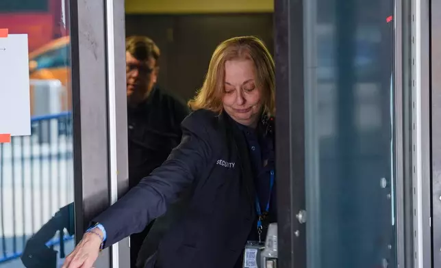 A security guard closes a door to Madison Square Garden after noticing members of the media outside, ahead of a reported wedding between singer Taylor Swift and National Football League player Travis Kelce on Thursday, July 2, 2026, in New York. (AP Photo/Ryan Murphy)