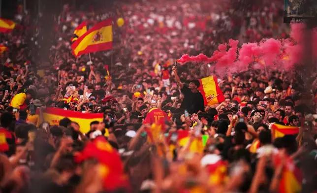 Fans wait for the arrival of players from Spain's national soccer team during celebrations in Madrid on Monday, July 20, 2026, after Spain defeated Argentina in the World Cup final in East Rutherford, N.J., near New York. (AP Photo/Manu Fernandez)