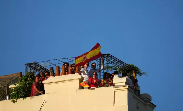 Fans wait for the arrival of players from Spain's national soccer team during celebrations in Madrid on Monday, July 20, 2026, after Spain defeated Argentina in the World Cup final in East Rutherford, N.J., near New York. (AP Photo/Manu Fernandez)