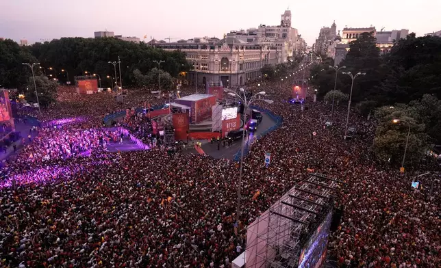 Fans crowd together as they wait for the arrival of players from Spain's national soccer team during celebrations in Cibeles square in Madrid on Monday, July 20, 2026, after Spain defeated Argentina in the World Cup final in East Rutherford, N.J., near New York. (AP Photo/Bernat Armangue)