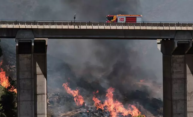 A firefighter truck next to a wildfire in Los Gallardos, near Almeria, Spain, Friday, July 10, 2026. (AP Photo/Gregorio Marrero)