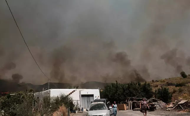 A wildfire rages in Alfajir, near Almeria in southeastern Spain, Friday, July 10, 2026. (AP Photo/Gregorio Marrero)