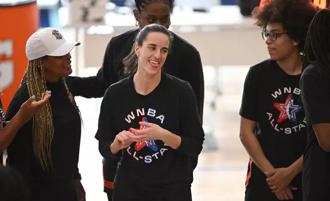 WNBA All-Star Caitlin Clark, center, reacts before practice at the Obama Presidential Center in Chicago, Friday, July 24, 2026. (AP Photo/Paul Beaty)