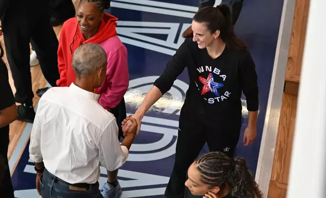 Former President Barack Obama, left, greets WNBA All-Star Caitlin Clark, right, during a practice at the Obama Presidential Center in Chicago, Friday, July 24, 2026. (AP Photo/Paul Beaty)