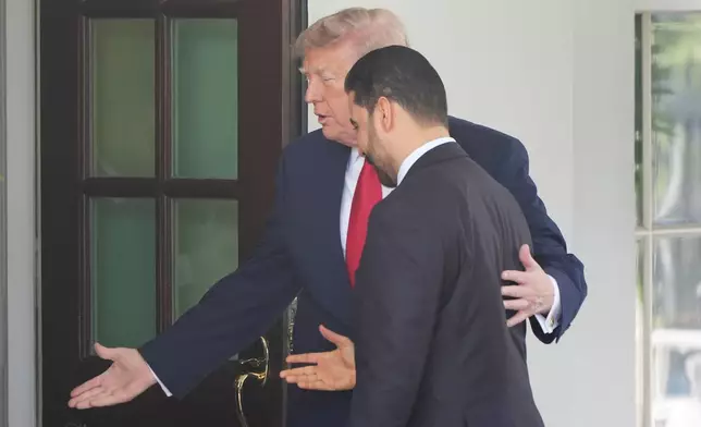 President Donald Trump with Iraq's Prime Minister Ali al-Zaidi as they walk into the White House together, Tuesday, July 14, 2026, in Washington.(AP Photo/Alex Brandon)