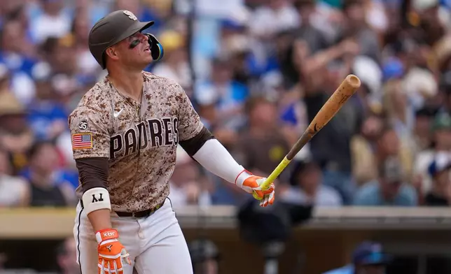 San Diego Padres' Ty France watches his sacrifice fly during the eighth inning of a baseball game against the Toronto Blue Jays Sunday, July 12, 2026, in San Diego. (AP Photo/Gregory Bull)