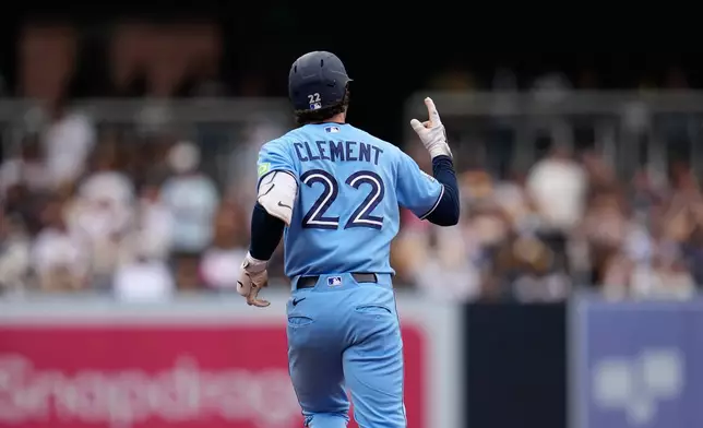 Toronto Blue Jays' Ernie Clement celebrates after hitting a two-run home run during the fourth inning of a baseball game against the San Diego Padres Sunday, July 12, 2026, in San Diego. (AP Photo/Gregory Bull)