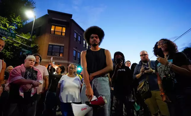 Attendees gather at a candlelight vigil where a Madison police officer shot and killed a man Wednesday, July 22, 2026, in Madison, Wis. (AP Photo/Kayla Wolf)