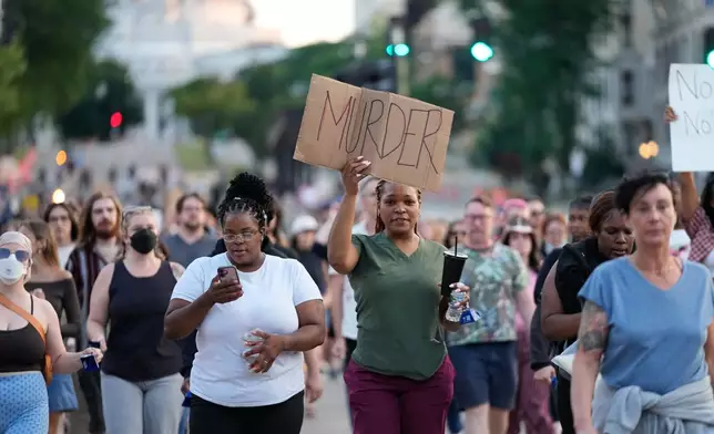 Protesters march after a Madison police officer shot and killed a man Wednesday, July 22, 2026, in Madison, Wis. (AP Photo/Kayla Wolf)