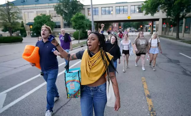 Protesters march after a Madison police officer shot and killed a man Wednesday, July 22, 2026, in Madison, Wis. (AP Photo/Kayla Wolf)