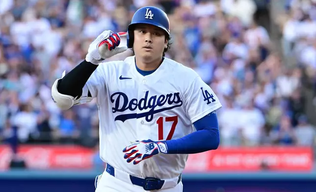 Los Angeles Dodgers Shohei Ohtani (17) celebrates his solo home run against the Seattle Mariners during the first inning of a baseball game Tuesday, July 28 2026, in Los Angeles. (AP Photo/Wally Skalij)