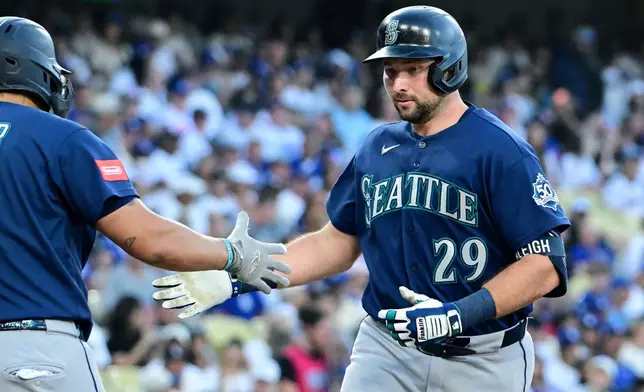 Seattle Mariners Cal Raleigh (29) celebrates his solo home run against the Los Angeles Dodgers during the second inning of a baseball game, Tuesday, July 28 2026, in Los Angeles. (AP Photo/Wally Skalij)