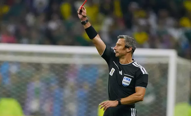 Referee Slavko Vincic of Slovenia shows a red card to Ecuador's Piero Hincapie (3) during the World Cup round of 32 soccer match between Mexico and Ecuador in Mexico City, Tuesday, June 30, 2026. (AP Photo/Natacha Pisarenko)
