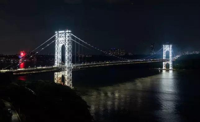 The George Washington Bridge's two towers are lit ahead of America's 250th birthday, Monday, June 29, 2026, in New York. (AP Photo/Adam Gray)