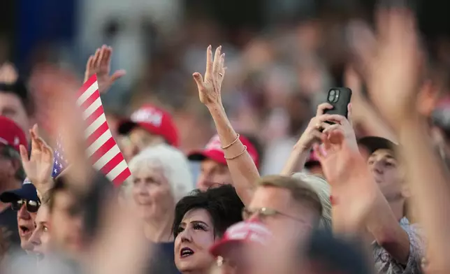 People listen before President Donald Trump speaks at the opening of the Great American State Fair on the National Mall, Wednesday, June 24, 2026, in Washington. (AP Photo/Alex Brandon)