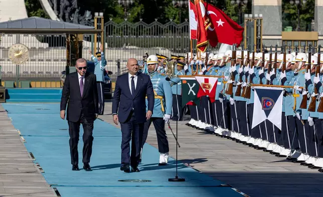 Turkish President Recep Tayyip Erdogan, left, and his Lebanese counterpart Joseph Aoun review an honor guard during a welcome ceremony before their meeting at the presidential palace in Ankara, Thursday, July 30, 2026. (Ugur Yildirim/DIA Photo via AP)