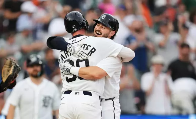 Detroit Tigers' Zach McKinstry celebrates his two-run home run with Kerry Carpenter (30) against the Athletics during the fifth inning of a baseball game Thursday, July 9, 2026, in Detroit. (AP Photo/Paul Sancya)