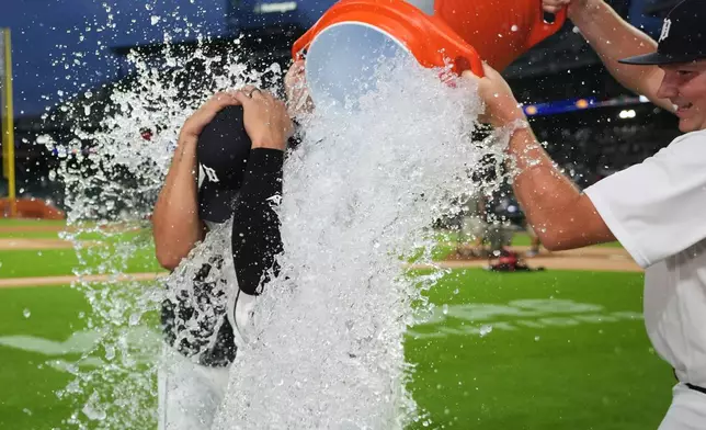 Detroit Tigers' Eduardo Valencia is doused by water after a baseball game against the Athletics Thursday, July 9, 2026, in Detroit. (AP Photo/Paul Sancya)