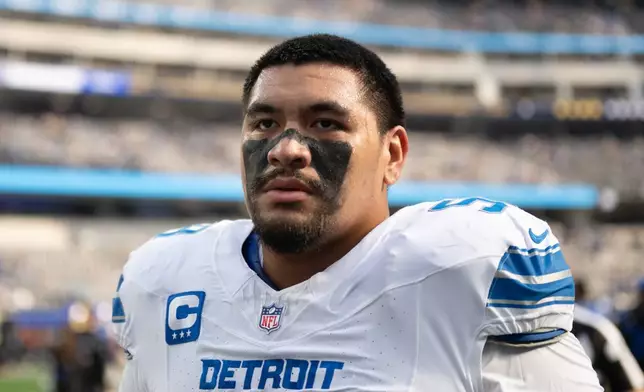 FILE - Detroit Lions offensive tackle Penei Sewell (58) walks back to the locker room before an NFL football game against the Los Angeles Rams, Dec. 14, 2025, in Inglewood, Calif. (AP Photo/Kyusung Gong, File)