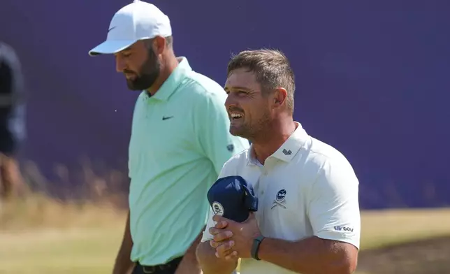 Bryson DeChambeau of the United States, right and Scottie Scheffler of the United States walks off the 18th green after completing their round, during the first day of the British Open Golf championships at Royal Birkdale golf club, in Southport, England, Thursday, July 16, 2026. (AP Photo/Jon Super)