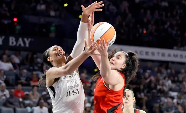 Las Vegas Aces center A'ja Wilson (22) and Portland Fire center Megan DiLeo fight for the ball during the first half of an WNBA basketball game Tuesday, July 28, 2026, in Las Vegas. (Steve Marcus/Las Vegas Sun via AP)