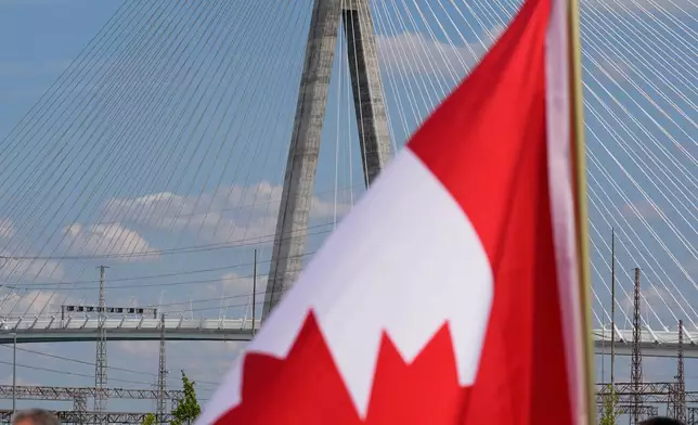A Canadian flag is displayed during a Canadian celebration marking the Gordie Howe International Bridge, which connects Detroit and Windsor, Ontario, on Friday, July 24, 2026, in Windsor, Ontario.. (AP Photo/Paul Sancya)