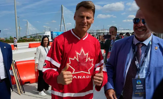 Gregor Robertson, Canadian Minister of Housing and Infrastructure gives thumbs up during a Canadian celebration for the Gordie Howe International bridge connecting Detroit and Windsor, Ontario Friday, July 24, 2026, in Windsor. (AP Photo/Paul Sancya)