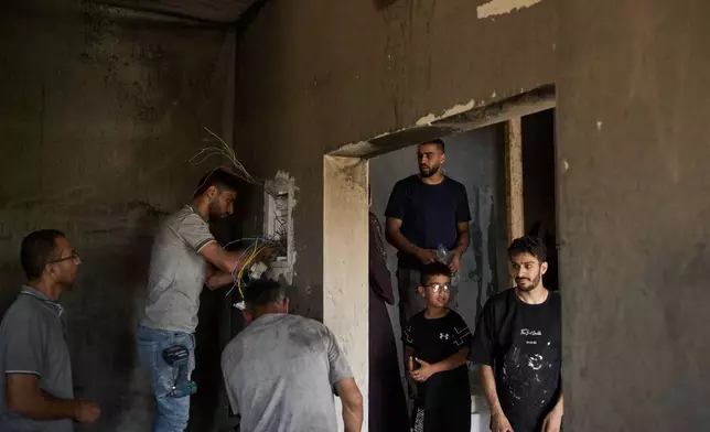 Palestinians repair a damaged house following an attack by Israeli settlers the previous day in the village of Sarra, near the West Bank city of Nablus, Saturday, July 25, 2026. (AP Photo/Leo Correa)