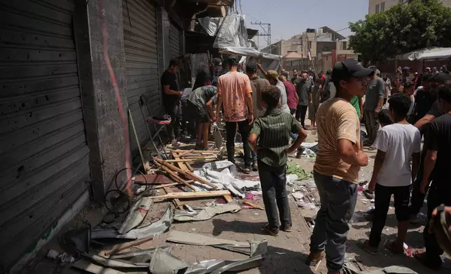 Palestinians inspect the site of an Israeli military strike, in Deir al-Balah, central Gaza Strip, Saturday, July 25, 2026. (AP Photo/Abdel Kareem Hana)