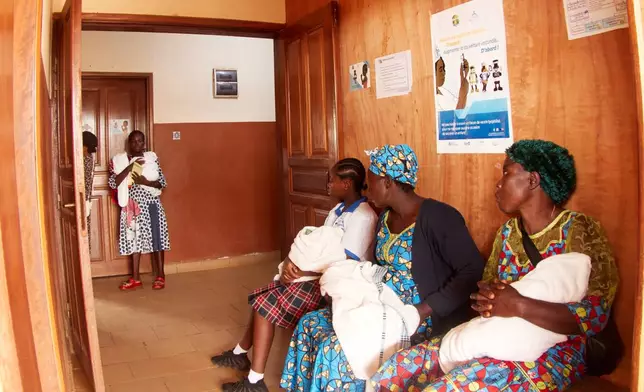 Mothers with their babies attend the malaria vaccination rollout at the Soa District Hospital in Yaounde, Cameroon, Wednesday, April 29, 2026. (AP Photo/Angel Ngwe)