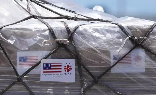 People load pallets containing food and hygiene kits for a humanitarian assistance flight to Cuba organized by the Trump administration as the U.S. continues to put pressure on the island's government, Tuesday, July 21, 2026, in Miami. (AP Photo/Lynne Sladky)
