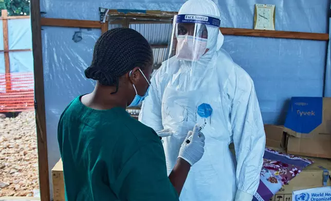 Health workers interact at the Evangelical Medical Center, in Bunia, eastern Congo, Friday, July 3, 2026, where Ebola clinical trials are scheduled to take place. (AP Photo/Dirole Lotsima Dieudonne)
