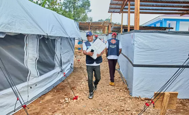 Health workers walk at the Evangelical Medical Center, in Bunia, eastern Congo, Friday, July 3, 2026, where Ebola clinical trials are scheduled to take place. (AP Photo/Dirole Lotsima Dieudonne)