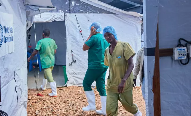 Health workers walk, at the Evangelical Medical Center, in Bunia, eastern Congo, Friday, July 3, 2026, where Ebola clinical trials are scheduled to take place. (AP Photo/Dirole Lotsima Dieudonne)