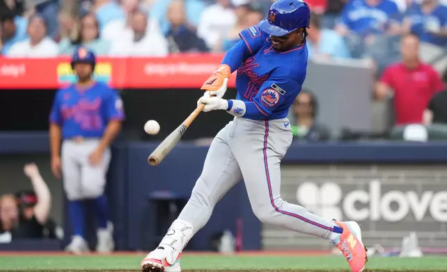 New York Mets shortstop Francisco Lindor (12) flies out against the Toronto Blue Jays during the second inning of a baseball game in Toronto on Tuesday, June 30, 2026. (Nathan Denette/The Canadian Press via AP)