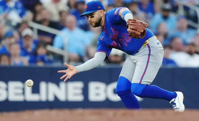 New York Mets third baseman Bo Bichette (19) fields the ball on a single by Toronto Blue Jays' George Springer during the fifth inning of a baseball game in Toronto on Tuesday, June 30, 2026. (Nathan Denette/The Canadian Press via AP)