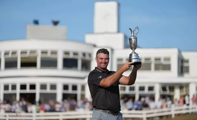 Ryan Fox of New Zealand poses with the Claret Jug trophy in front of the club house, after winning the British Open Golf championships at Royal Birkdale golf club, in Southport, England, Sunday, July 19, 2026. (AP Photo/Jon Super)