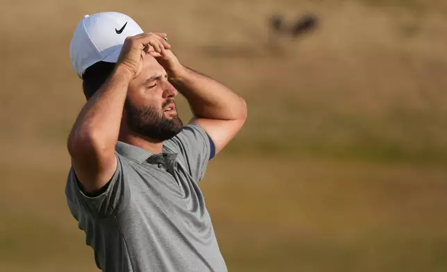Scottie Scheffler of the United States adjusts his hat on the 18th green during the third day of the British Open Golf championships at Royal Birkdale golf club, in Southport, England, Saturday, July 18, 2026. (AP Photo/Jon Super)