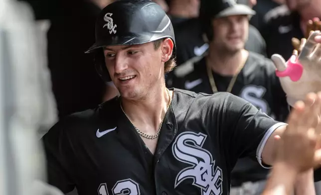 Chicago White Sox's Colson Montgomery is congratulated by teammates after hitting a two-run home run off Cleveland Guardians starting pitcher Tanner Bibee during the third inning of a baseball game, Sunday, July 5, 2026, in Cleveland. (AP Photo/Phil Long)