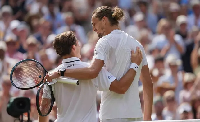 Alexander Zverev of Germany, right speaks to Arthur Fery of Britain at the net after Zverev won their men's singles semifinal match at the Wimbledon Tennis Championships in London, Friday, July 10, 2026. (AP Photo/Kirsty Wigglesworth)