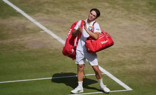 Arthur Fery of Britain applauds to the public as he leaves the court after losing to Alexander Zverev of Germany in their men's singles semifinal match at the Wimbledon Tennis Championships in London, Friday, July 10, 2026. (AP Photo/Kin Cheung)