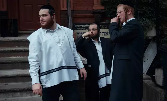FILE - Hasidic Jewish men chat on June 16, 2025, in the Brooklyn borough of New York. (AP Photo/Andres Kudacki, File)