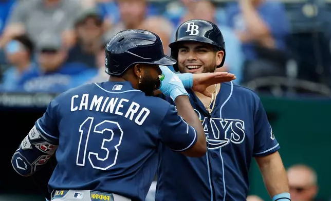Tampa Bay Rays' Junior Caminero (13) celebrates his two-run home run with Jonathan Aranda, right, during the first inning of a baseball game against the Kansas City Royals in Kansas City, Mo., Wednesday, July 1, 2026. (AP Photo/Colin E. Braley)