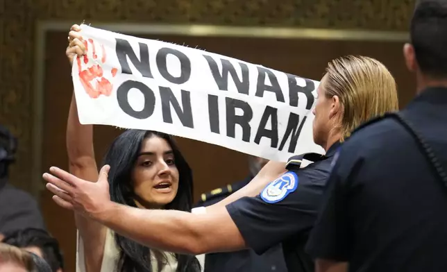 U.S. Capitol Police remove a protester as Defense Secretary Pete Hegseth testifies at a Senate Appropriations Committee hearing, Tuesday, July 21, 2026, on Capitol Hill in Washington. (AP Photo/Jacquelyn Martin)